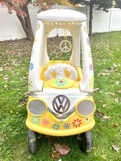 a yellow and white toy car sitting in the grass