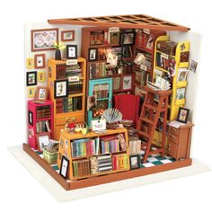 a doll house with bookshelves, ladders and pictures on the wall in it