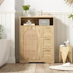 a wooden cabinet sitting in the corner of a room next to a bathtub and toilet