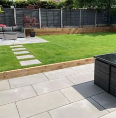 an outdoor patio area with grass and furniture