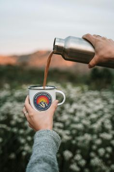 someone is pouring coffee into a cup