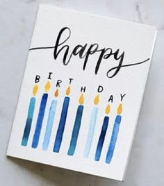 a birthday card with candles on it and the words happy birthday written in black ink