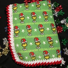 an oven mitt covered in green fabric with red and white trim, surrounded by christmas decorations