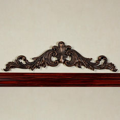 an ornate wooden shelf on the wall