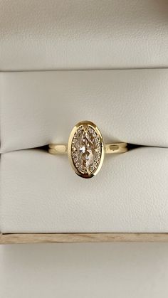 a diamond ring sitting on top of a white box