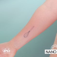 a woman's arm with a tattoo on it that has a whisk in it