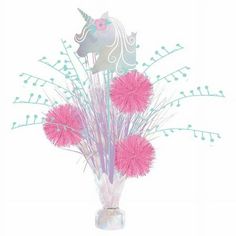 a vase filled with pink pom - poms and a unicorn head on top