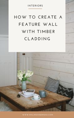 a wooden table with white flowers on it and the words how to create a feature wall with timber cladding