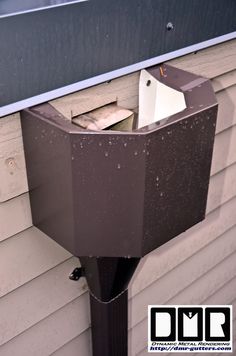 a close up of a mailbox on the side of a house