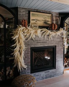 a living room with a fire place and a painting on the fireplace mantels