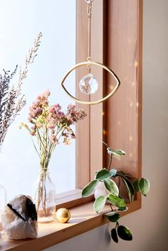 a window sill with vases and flowers on it