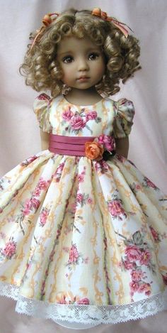 a doll wearing a dress with flowers on it