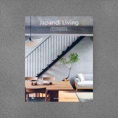 the cover of japan living magazine with a table and chairs in front of it, next to a stair case