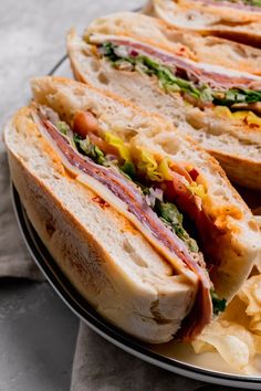 two sandwiches on a plate with potato chips