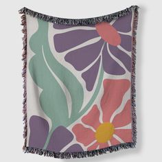 a multicolored flower and leaf print throw blanket with fringes on the edges