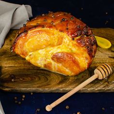 a piece of bread sitting on top of a cutting board next to a wooden spoon