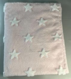 a pink blanket with white stars on it