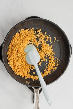 a frying pan filled with food and a spatula on top of the skillet