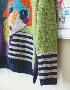 a colorful sweater hanging on the wall