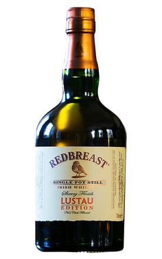 a bottle of redbreast wine sitting on top of a table