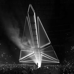 a black and white photo of a stage with a sailboat on it's side