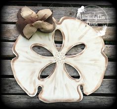 a decorative wooden plate with a bow on it