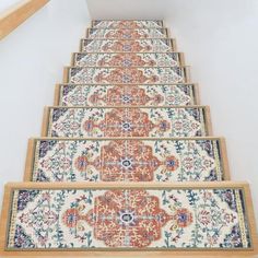 a carpeted staircase leading up to the top of a set of stairs in a home