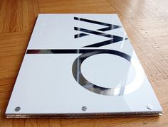 a close up of a metal plate on a wooden table with wood flooring and hard wood floors