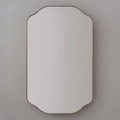 an oval mirror mounted to the side of a wall