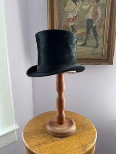 Edwardian Top Hat, Gentleman Hat, Victorian High Hat, Early 1900s Paulson Hat, Antique Paulson Hat, Magician Hat, High Hat, Steampunk Hat  Exquisite antique gentleman's hat. So stately and elegant. The epitome of high fashion for men. Overall, excellent vintage condition with no glaring flaws. A little dent at side that I'm certain could be steamed out. Brand name is Paulson and apparently made or made to be sold in Pittsburg. Such a museum quality piece. Very rare and incredible. Fabric feels like a silk velvet or possible beaver fur.  This hat was intended to sit at the top of the head (not down onto it) and therefore circumference measurement seems small but this was the style.  Measurements - - -  Circumference: 21 1/4 inches  Height from brim to top: just shy of 6 inches  Brim length Magician Hat, Men Overall, Gentleman Hat, High Hat, Steampunk Hat, Cover Ideas, Fashion For Men, Silk Velvet, Mens Costumes