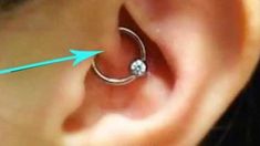 an ear piercing is shown with blue arrows pointing to the side