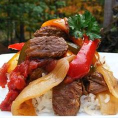 a white plate topped with meat and vegetables