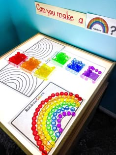 a child's table that has been made to look like a rainbow with the words can you make a? on it