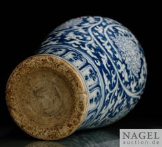 a blue and white vase sitting on top of a table