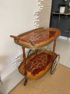 two wooden serving trays with wheels on the floor