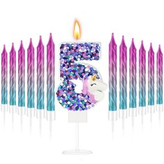 the number five is surrounded by candles with unicorns and stars on them in front of a white background