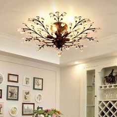 a dining room table with chairs and a vase filled with flowers sitting on top of it