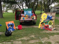 the sesame street characters are on display in front of their art work at an outdoor event