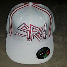 a white snap back hat with the word spa on it in red and silver letters