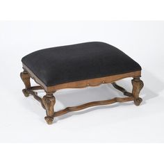 a wooden bench with a black cushion on it's back and legs, sitting against a white background