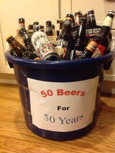 a bucket filled with beer bottles sitting on top of a wooden floor