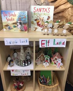 children's books and crafts displayed on wooden shelves