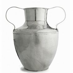 a large metal vase with two handles on the top and bottom, sitting in front of a white background