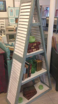 an upside down shelf with books on it in a room filled with furniture and decor