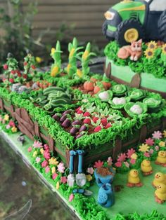 a cake decorated with farm animals and plants