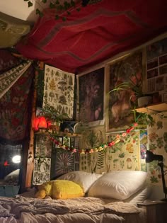 a bed in a room with pictures on the wall and lights hanging from the ceiling