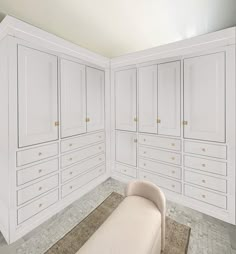 an empty room with white cabinets and a beige bench in the middle of the room