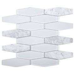 a white tile wall with hexagonal tiles in the shape of hexagons