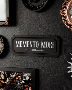 there is a sign that says mementoo mori on the wall next to pictures