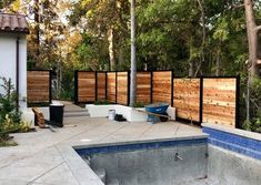 an outdoor swimming pool surrounded by wooden fences